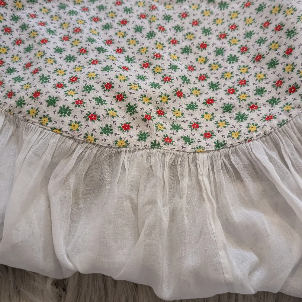 Vintage handmade white apron with red, green and red floral print.